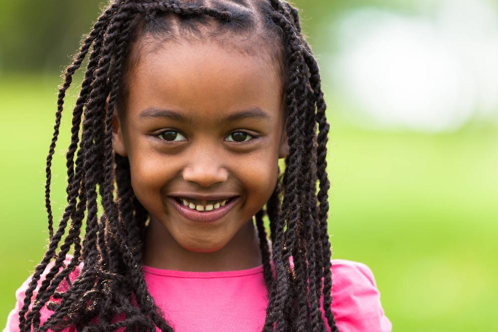 young girl with sun hat smiling