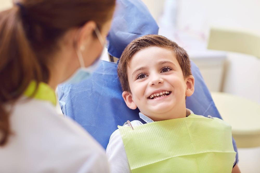 young boy sitting in dental chair 
