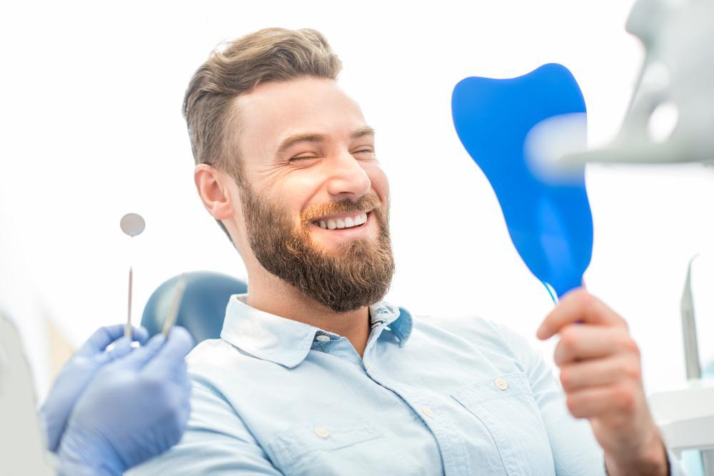 man smiling after getting restorative dental care