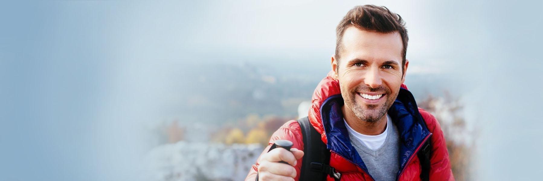 Young man hiking & smiling l Cosmetic dentistry Casuarina NT