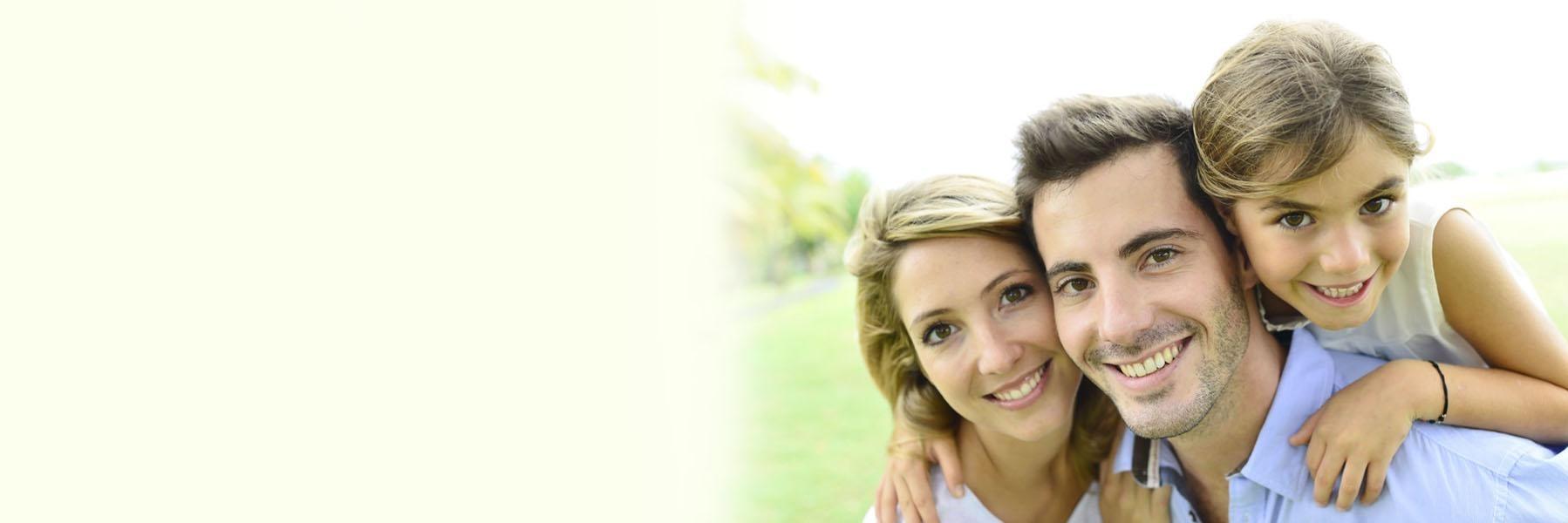Young family of three smiling l Dental insurance Casuarina Square Dental Care