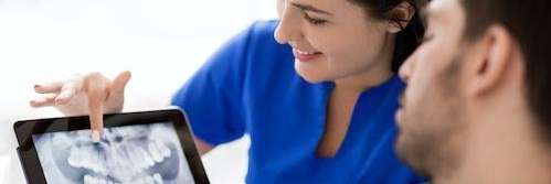 dentist showing patient a dental xray