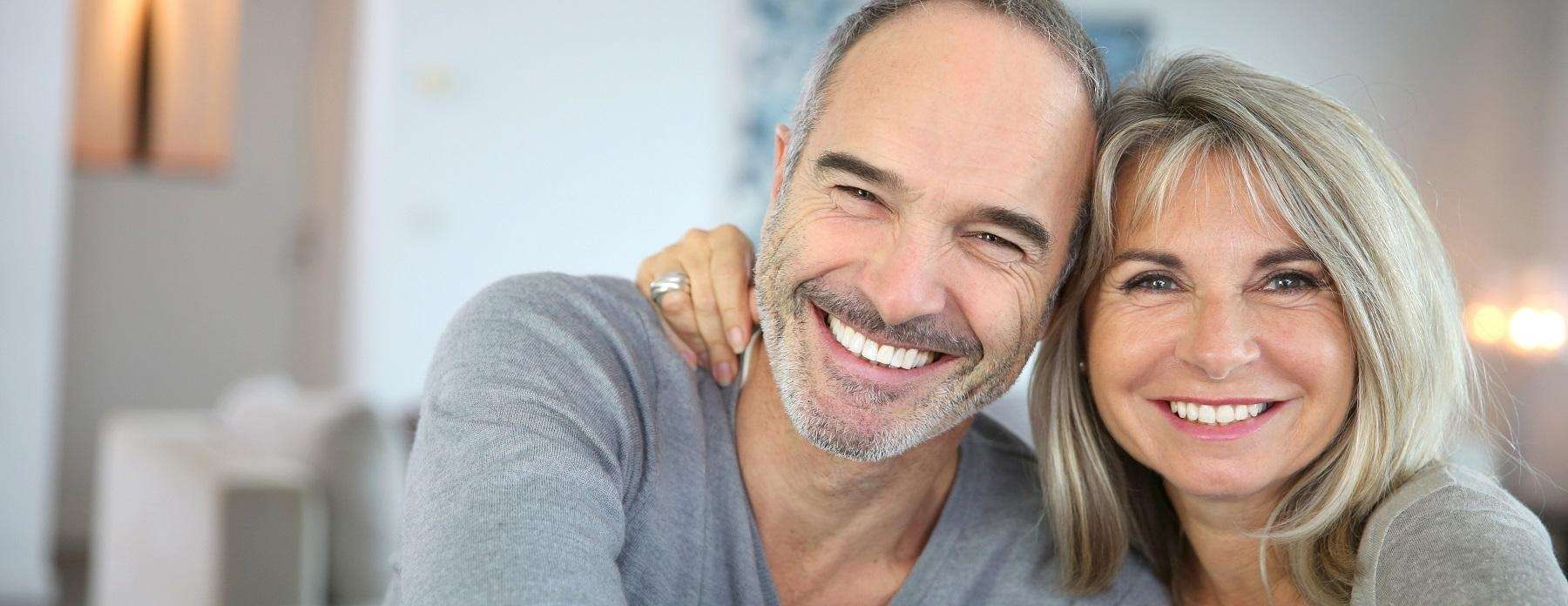 couple smiling widely with their dental implants in Casuarina NT