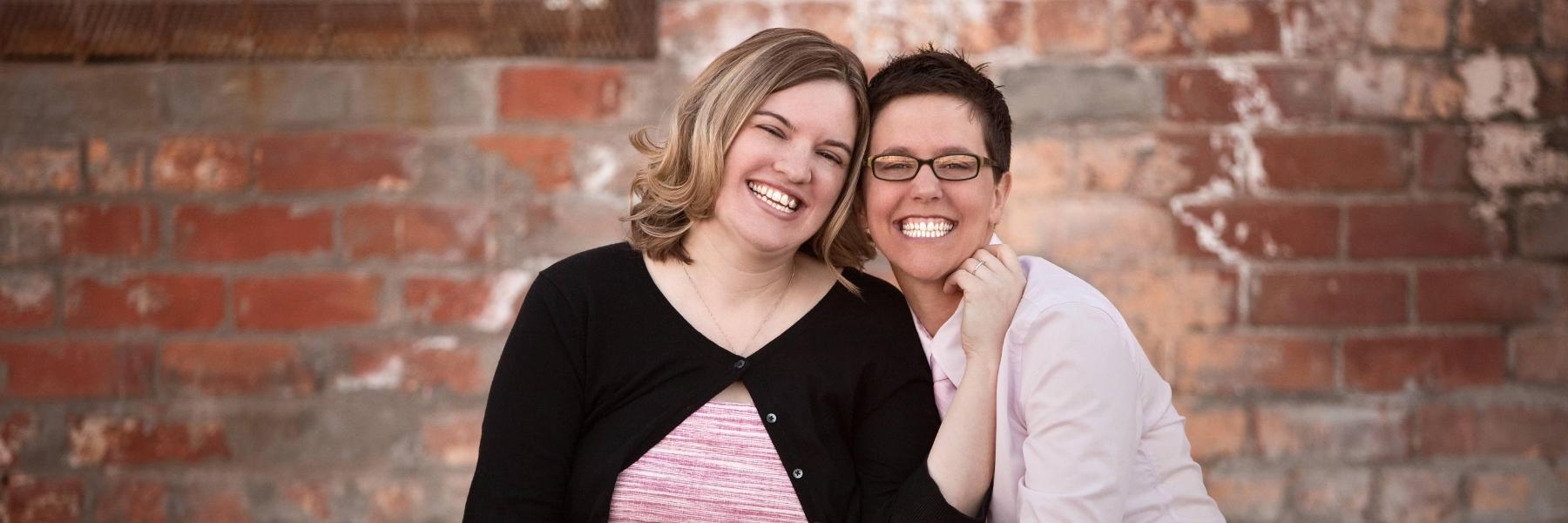 a woman and her wife smiling with bright smiles