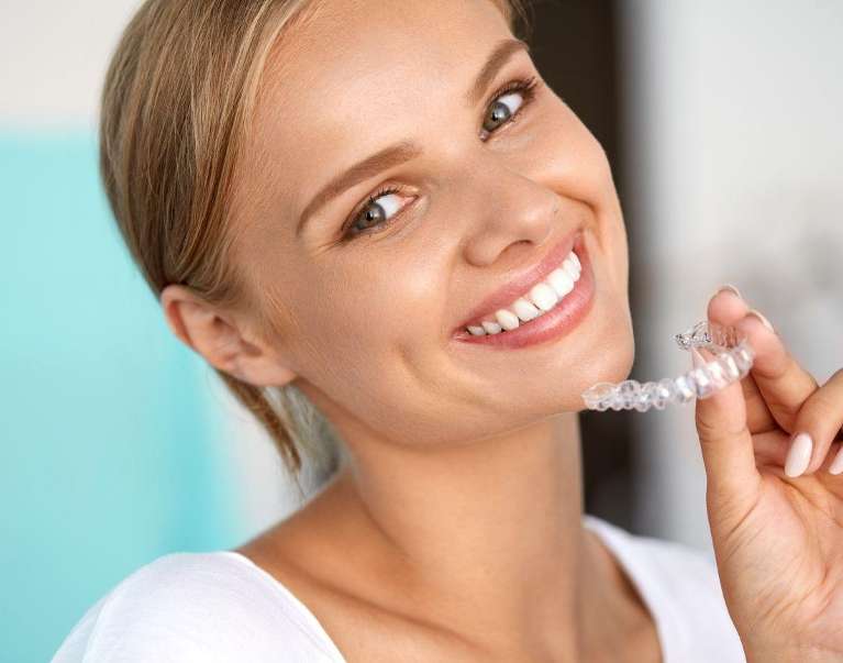 A woman smiling after getting Invisalign® in Casuarina, NT