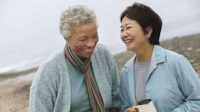 two middle-aged women smiling