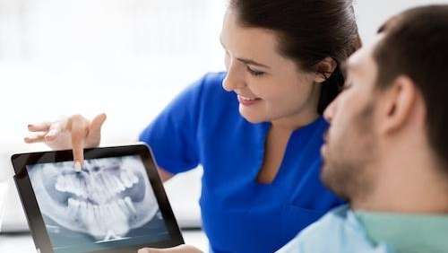 dentist showing a patient a digital dental xray