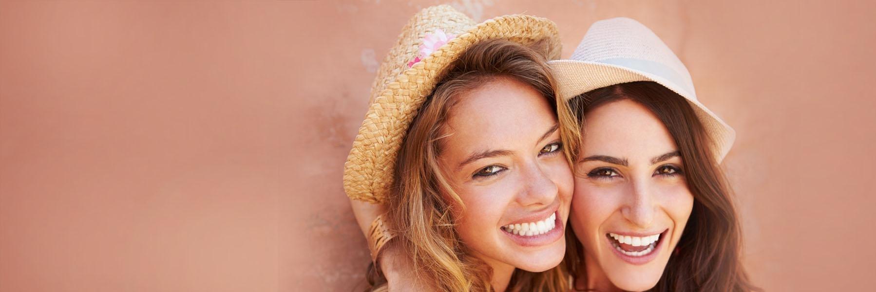 Two women in hats smiling in darwin